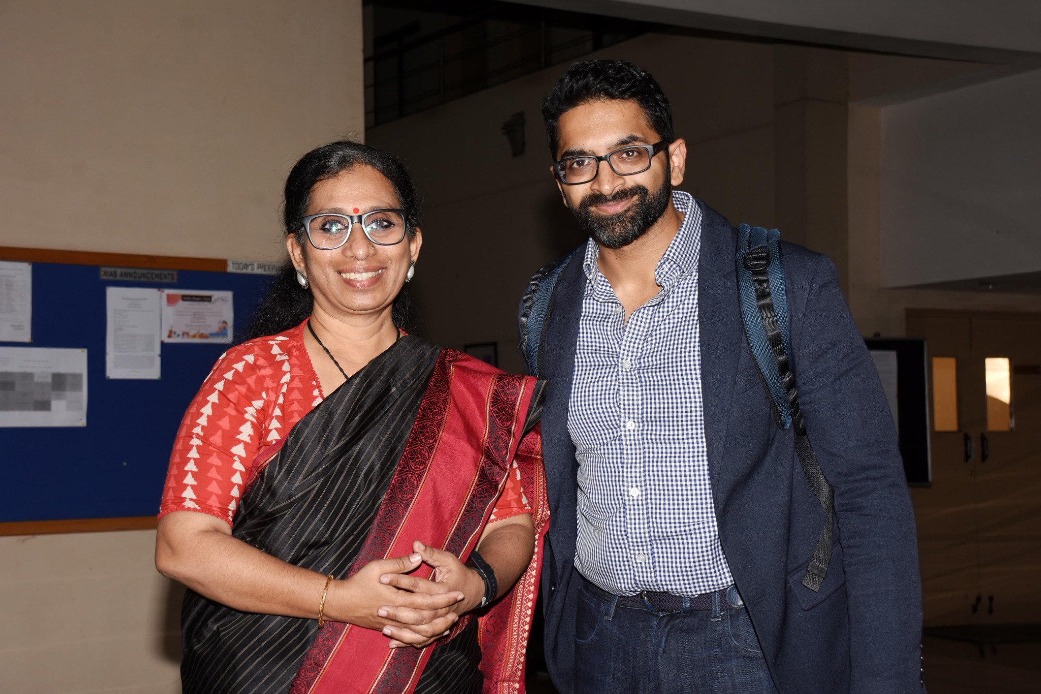 Two participants standing together during an event at the National Institute of Advanced Studies